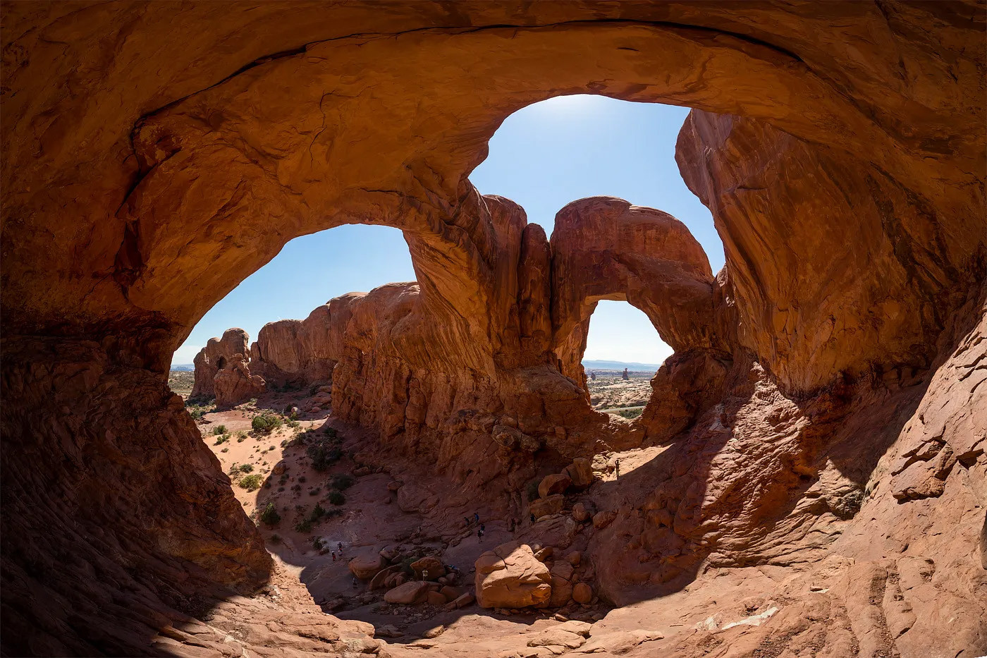A landscape shot of Double Arch from underneath. 
